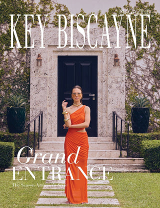 Key Biscayne Magazine, August 2026 cover: Kate Svetla in an orange gown wearing L’Écurie Paris Lissa Amber sunglasses