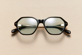 Audrey Black sunglasses by L'Écurie Paris, hexagonal polished black acetate frame with dusty blue lenses and 18K gold-plated titanium temples
