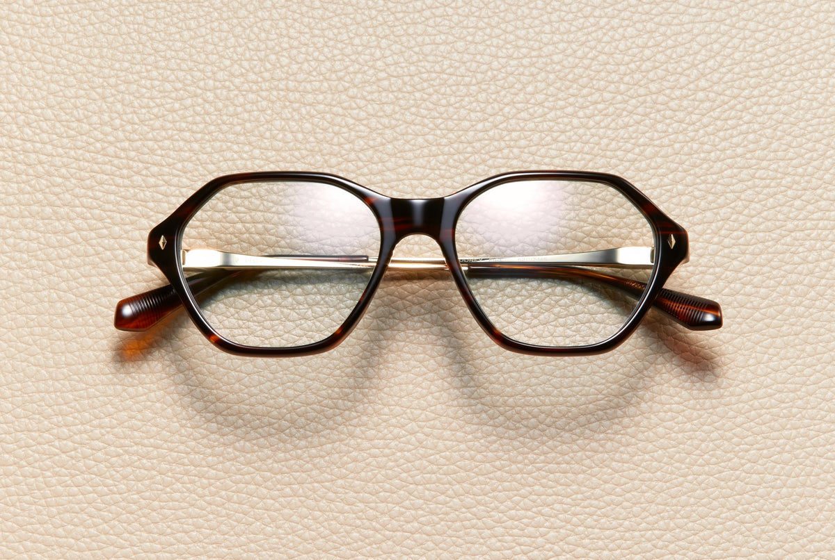 Audrey Fire optical frame by L'Écurie Paris, hexagonal red-brown fire acetate with 18K gold-plated titanium temples, prescription ready