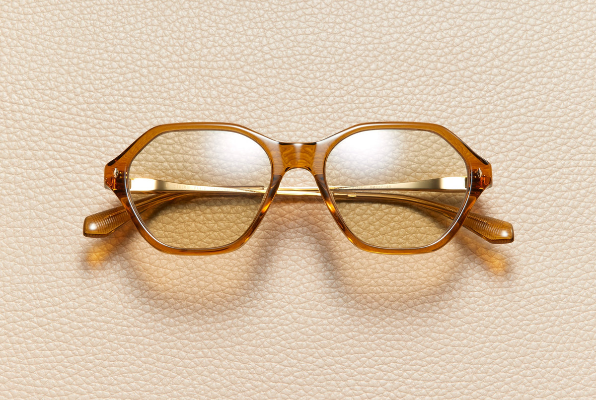 Audrey Honey sunglasses by L'Écurie Paris, hexagonal translucent honey acetate frame with light amber lenses and 18K gold-plated titanium temples