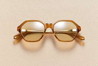 Audrey Honey sunglasses by L'Écurie Paris, hexagonal translucent honey acetate frame with light amber lenses and 18K gold-plated titanium temples