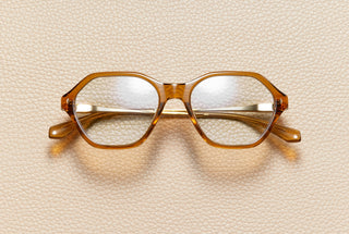 Audrey Honey optical frame by L'Écurie Paris, hexagonal translucent honey acetate with 18K gold-plated titanium temples, prescription ready