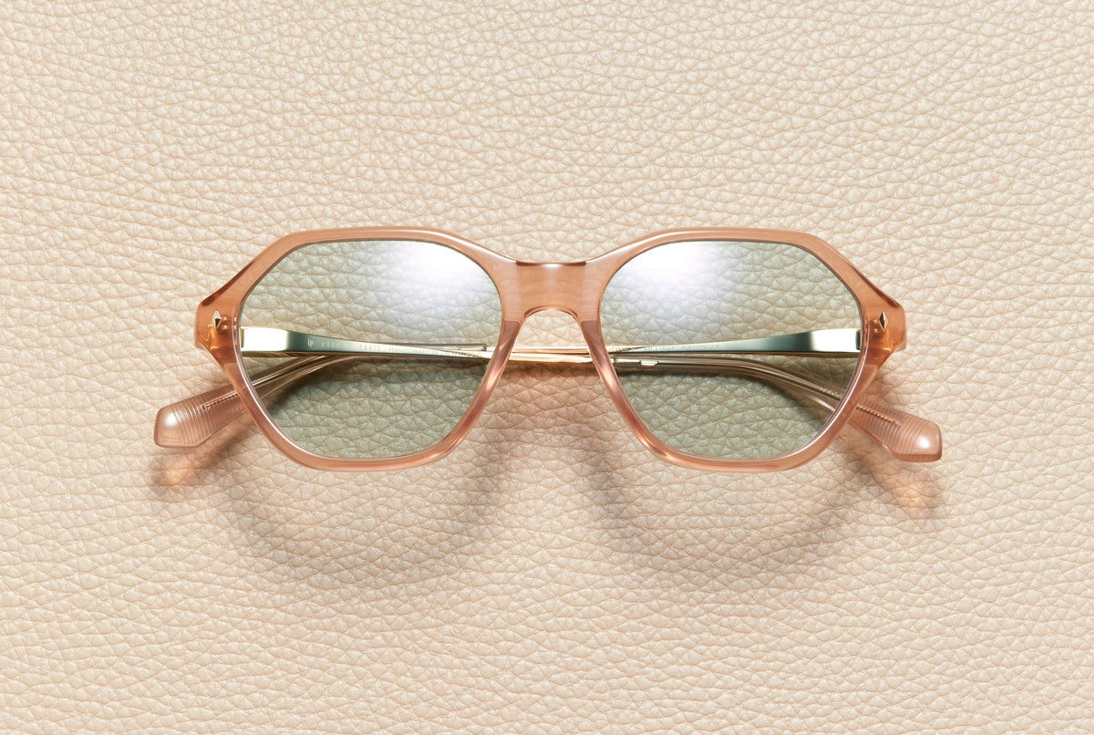 Audrey Blush sunglasses by L'Écurie Paris, hexagonal translucent blush acetate frame with sand lenses and 18K gold-plated titanium temples
