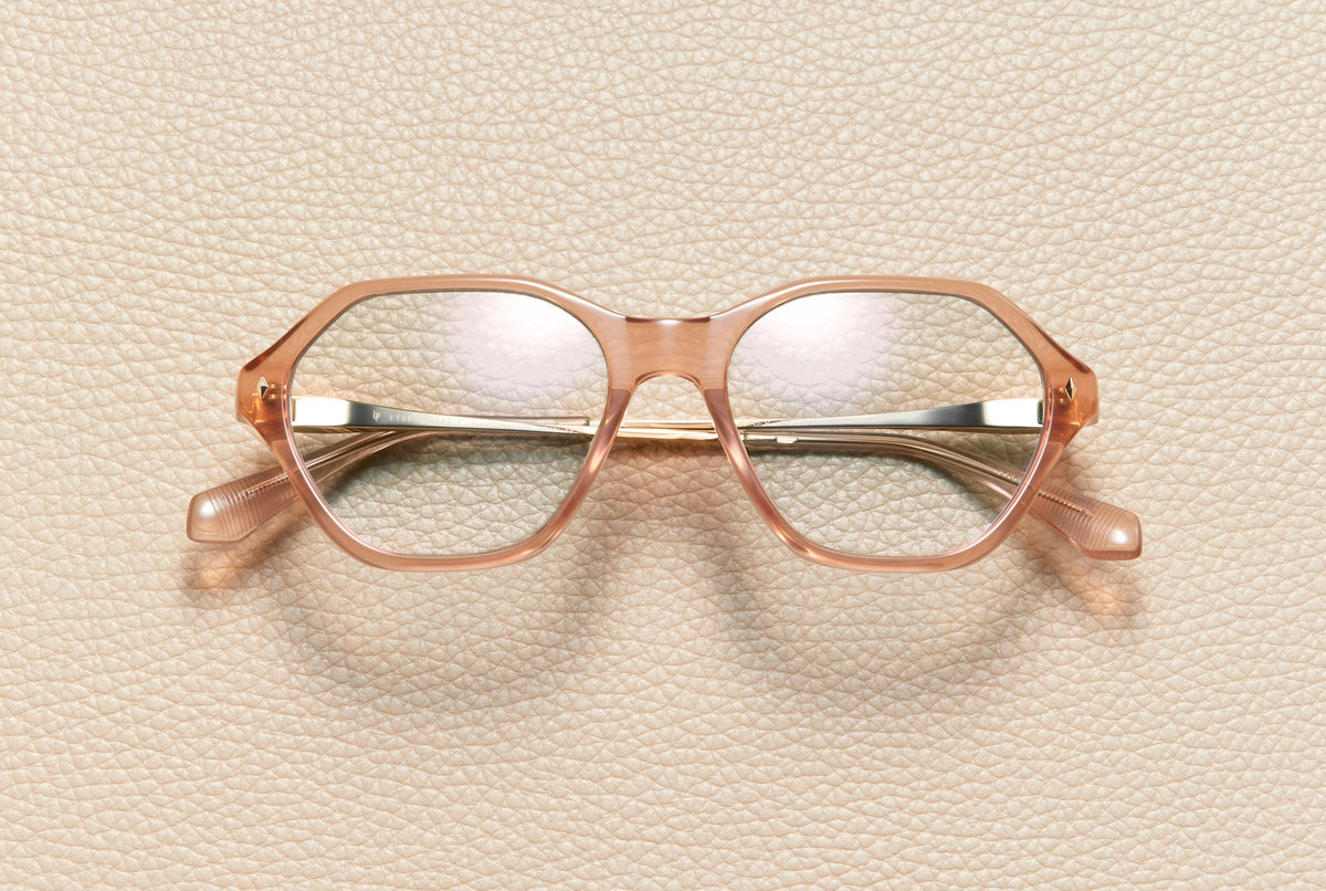 Audrey Blush optical frame by L'Écurie Paris, hexagonal translucent blush acetate with 18K gold-plated titanium temples, prescription ready
