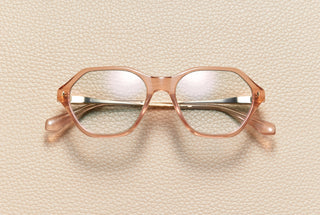 Audrey Blush optical frame by L'Écurie Paris, hexagonal translucent blush acetate with 18K gold-plated titanium temples, prescription ready
