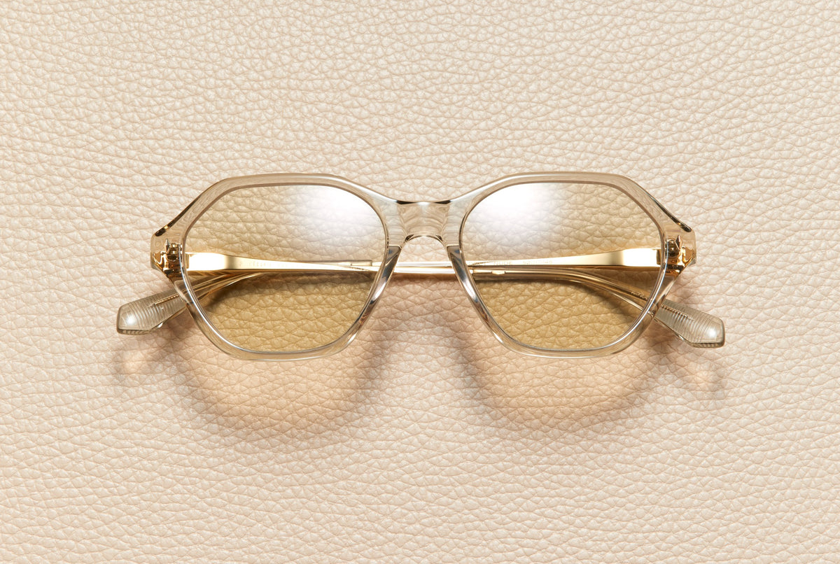 Audrey Nude sunglasses by L'Écurie Paris, hexagonal translucent nude acetate frame with dusty blue lenses and 18K gold-plated titanium temples