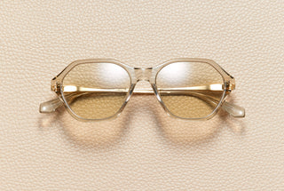 Audrey Nude sunglasses by L'Écurie Paris, hexagonal translucent nude acetate frame with dusty blue lenses and 18K gold-plated titanium temples