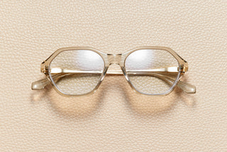 Audrey Nude optical frame by L'Écurie Paris, hexagonal translucent nude acetate with 18K gold-plated titanium temples, prescription ready