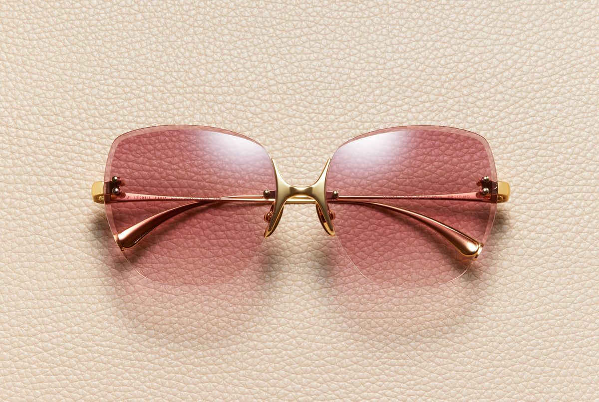 Romy rimless butterfly sunglasses in 24K gold-plated titanium with lacquered red gradient lenses by L'Écurie Paris