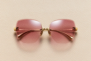 Romy rimless butterfly sunglasses in 24K gold-plated titanium with lacquered red gradient lenses by L'Écurie Paris