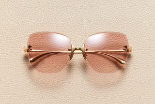 Romy rimless butterfly sunglasses in 18K gold-plated titanium with powdered pink gradient lenses by L'Écurie Paris