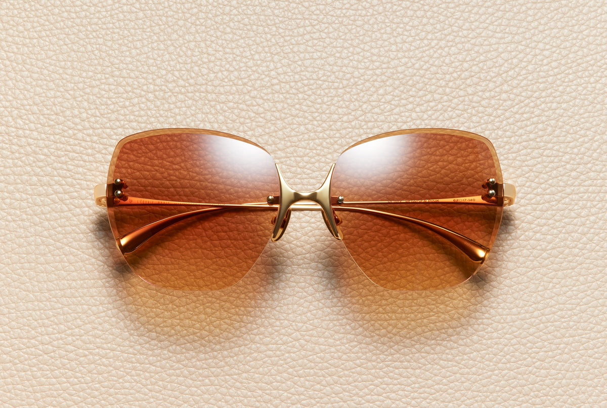 Romy rimless butterfly sunglasses in 18K gold-plated titanium with dark coffee gradient lenses by L'Écurie Paris