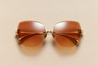 Romy rimless butterfly sunglasses in 18K gold-plated titanium with dark coffee gradient lenses by L'Écurie Paris