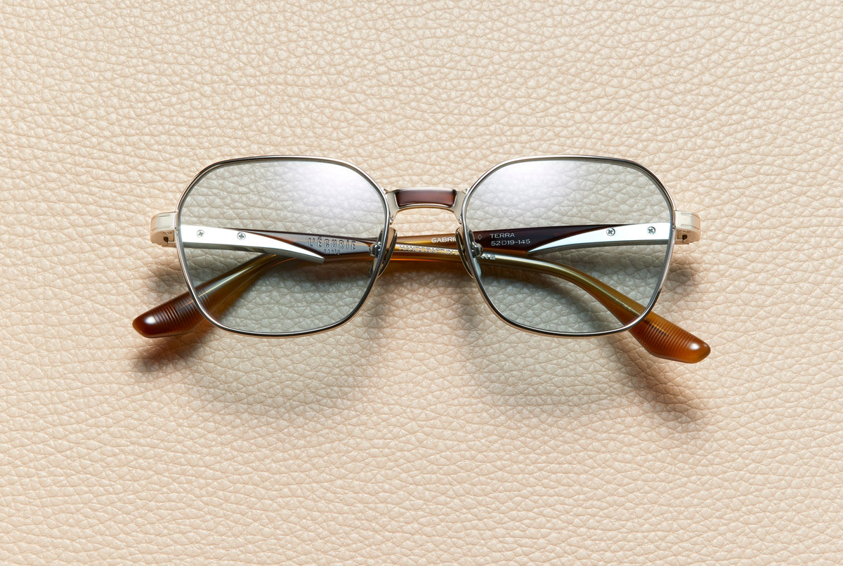 Gabrielle Terra sunglasses by L'Écurie Paris, geometric 14K white gold-plated titanium frame with terra acetate and dusty blue lenses