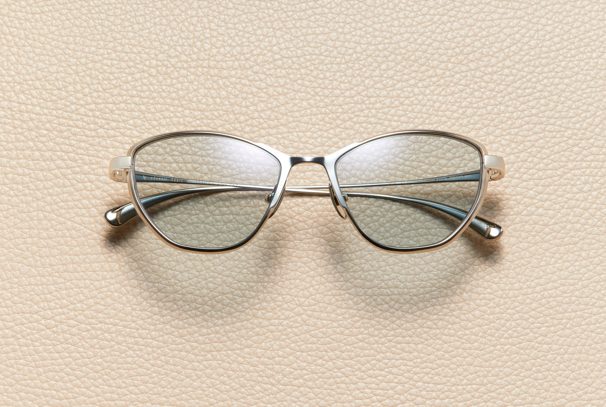 Mia cat-eye sunglasses in 14K white gold plated titanium with dusty blue lenses by L'Écurie Paris