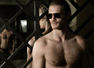 John VanBeber wearing L'Ecurie Paris sunglasses in a mirrored interior, Fashion For Men editorial