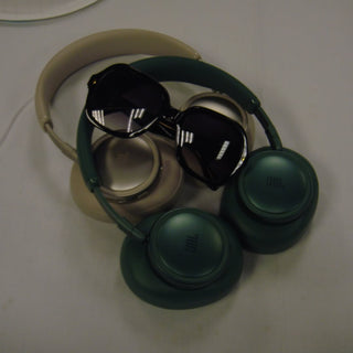 Benson Boone's L'Écurie Paris Elsa Black sunglasses resting on a pair of headphones