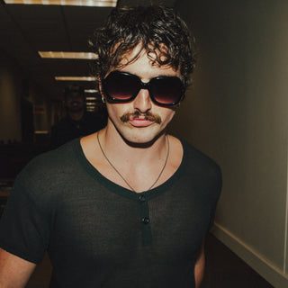 Benson Boone backstage on The Wanted Man Tour wearing L'Écurie Paris Elsa Black sunglasses, photographed by Shayden Schoonover