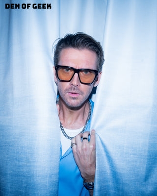 Dan Stevens in L'Écurie Paris Victor Black sunglasses behind a curtain, Den of Geek studio at Comic-Con 2026