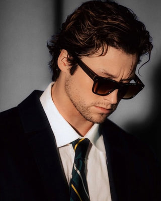 Stephen Kalyn wearing L'Écurie Paris Riviera sunglasses in Teak acetate with brown gradient lenses