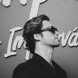 Stephen Kalyn in profile wearing L'Écurie Paris Riviera Smoke acetate sunglasses, black and white